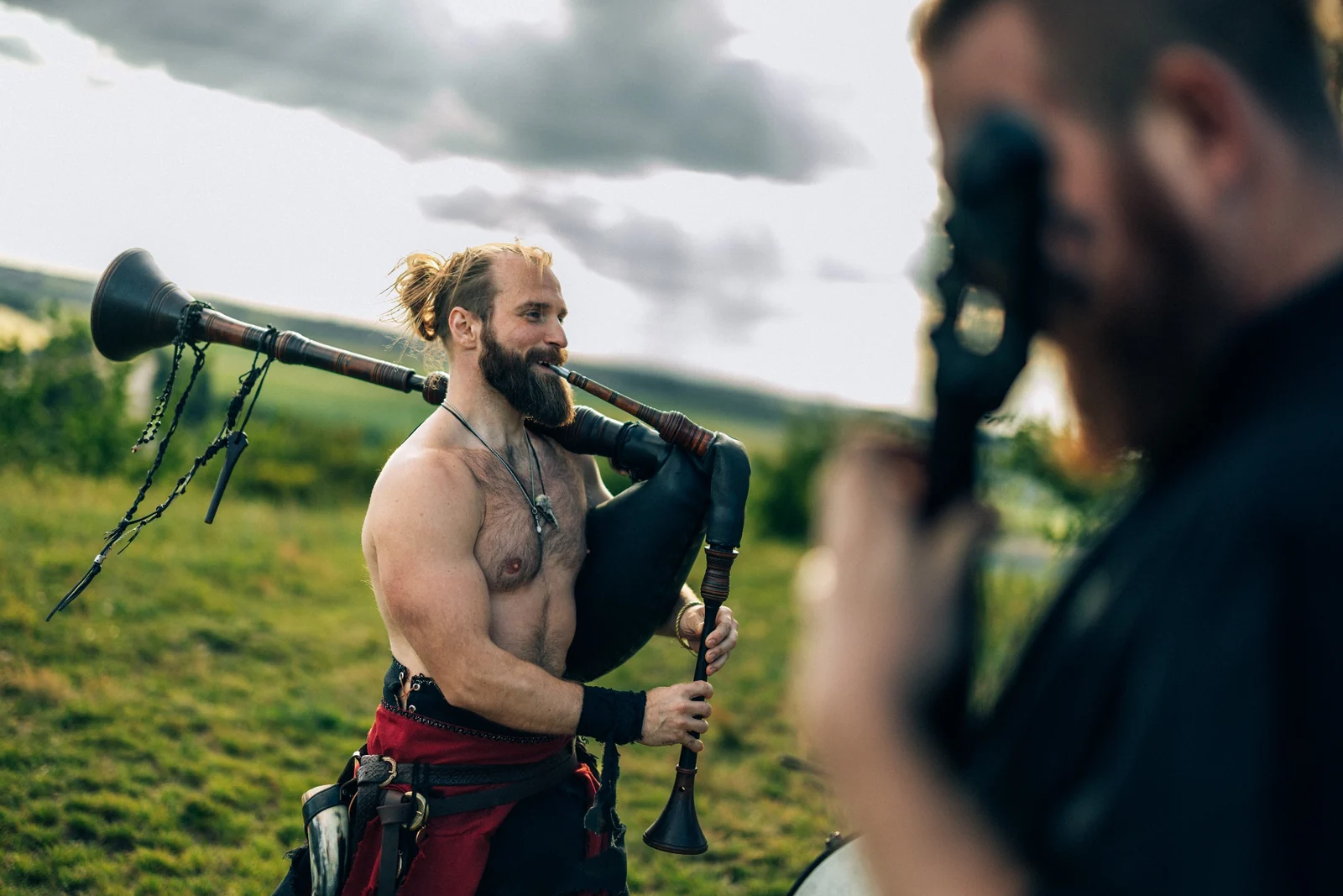 Musician playing bagpipes at an outdoor historical event